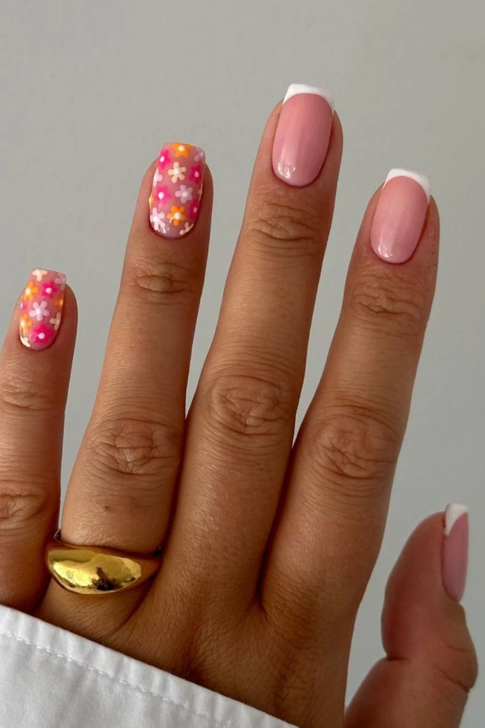 Flower nail designs are trendy, customizable, and easy to create using dotting tools and nail polish.  While traditionally associated with spring, floral nail designs can be embraced year-round by adjusting color palettes to suit the summer, fall or winter.  They work well on natural nails as well as acryllic, gel, or dip nails.  You can also add rhinestones.  Simple, short nails, french tips, almond, blue, pink, green, coffin, white, purple, cute, simple.