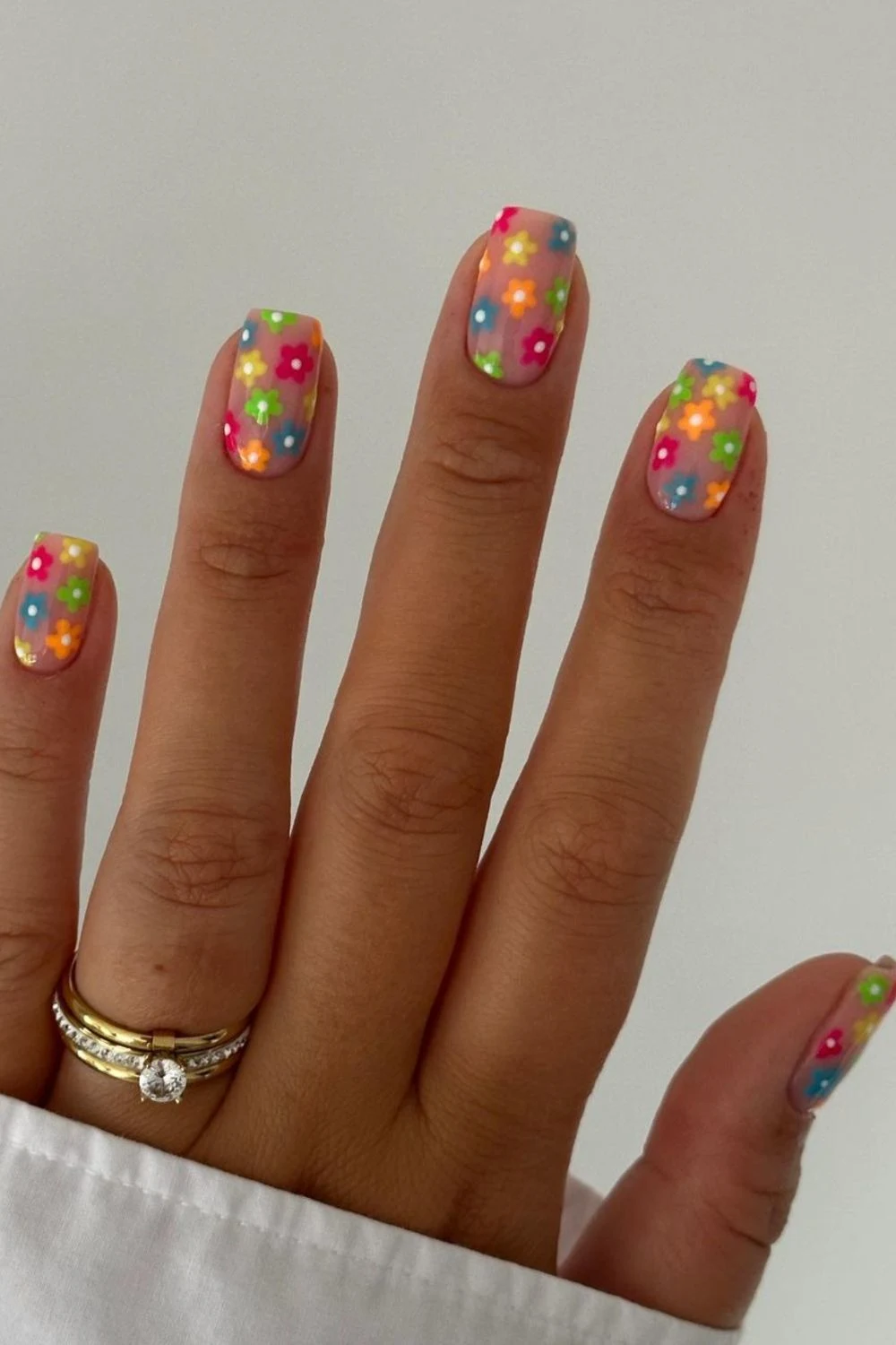 Flower nail designs are trendy, customizable, and easy to create using dotting tools and nail polish.  While traditionally associated with spring, floral nail designs can be embraced year-round by adjusting color palettes to suit the summer, fall or winter.  They work well on natural nails as well as acryllic, gel, or dip nails.  You can also add rhinestones.  Simple, short nails, french tips, almond, blue, pink, green, coffin, white, purple, cute, simple.