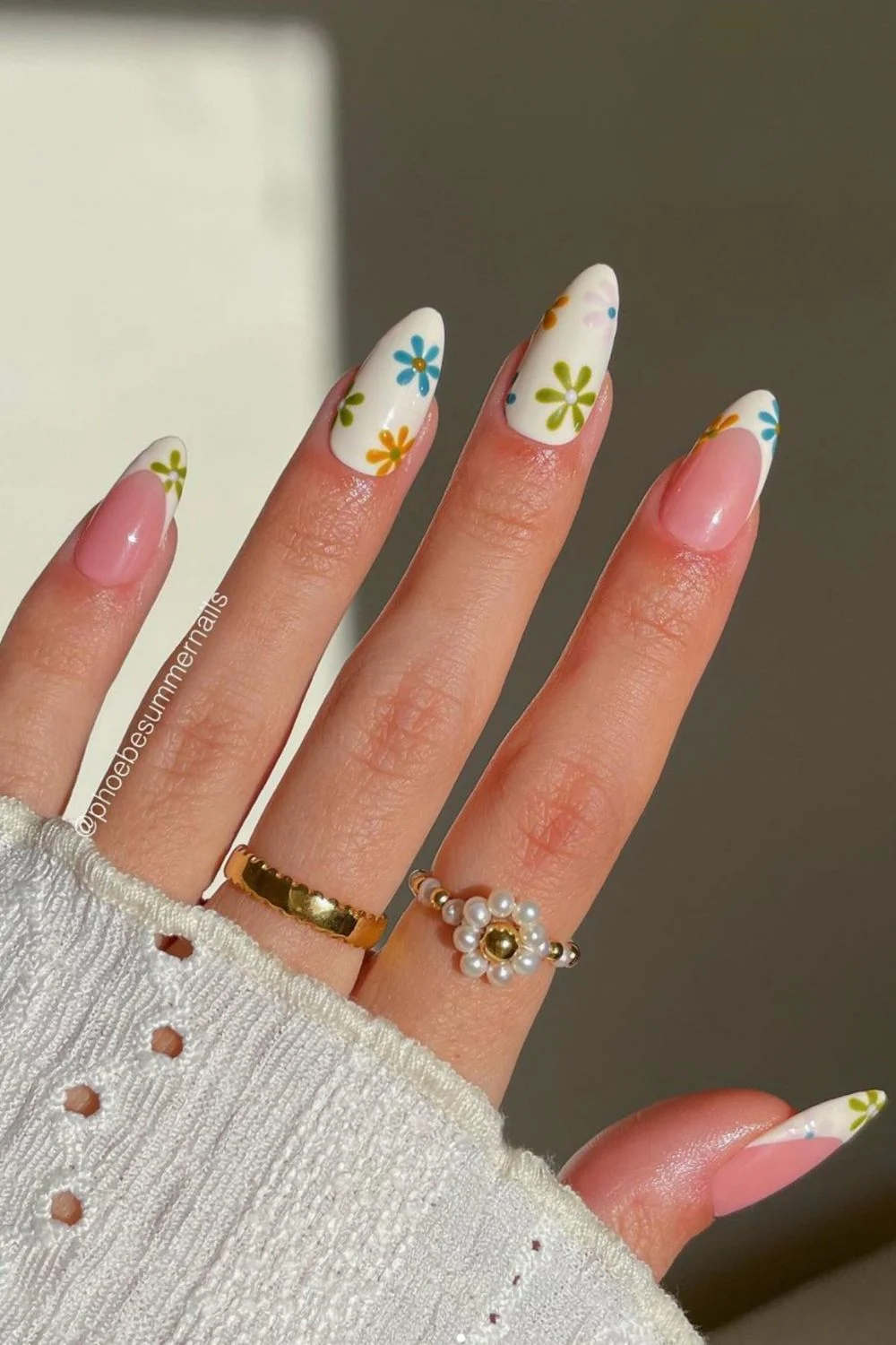 Flower nail designs are trendy, customizable, and easy to create using dotting tools and nail polish. While traditionally associated with spring, floral nail designs can be embraced year-round by adjusting color palettes to suit the summer, fall or winter. They work well on natural nails as well as acryllic, gel, or dip nails. You can also add rhinestones. Simple, short nails, french tips, almond, blue, pink, green, coffin, white, purple, cute, simple.
