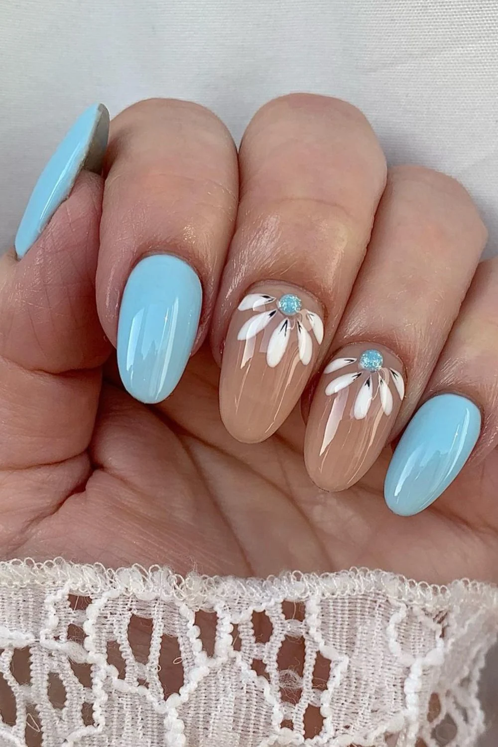 Flower nail designs are trendy, customizable, and easy to create using dotting tools and nail polish. While traditionally associated with spring, floral nail designs can be embraced year-round by adjusting color palettes to suit the summer, fall or winter. They work well on natural nails as well as acryllic, gel, or dip nails. You can also add rhinestones. Simple, short nails, french tips, almond, blue, pink, green, coffin, white, purple, cute, simple.