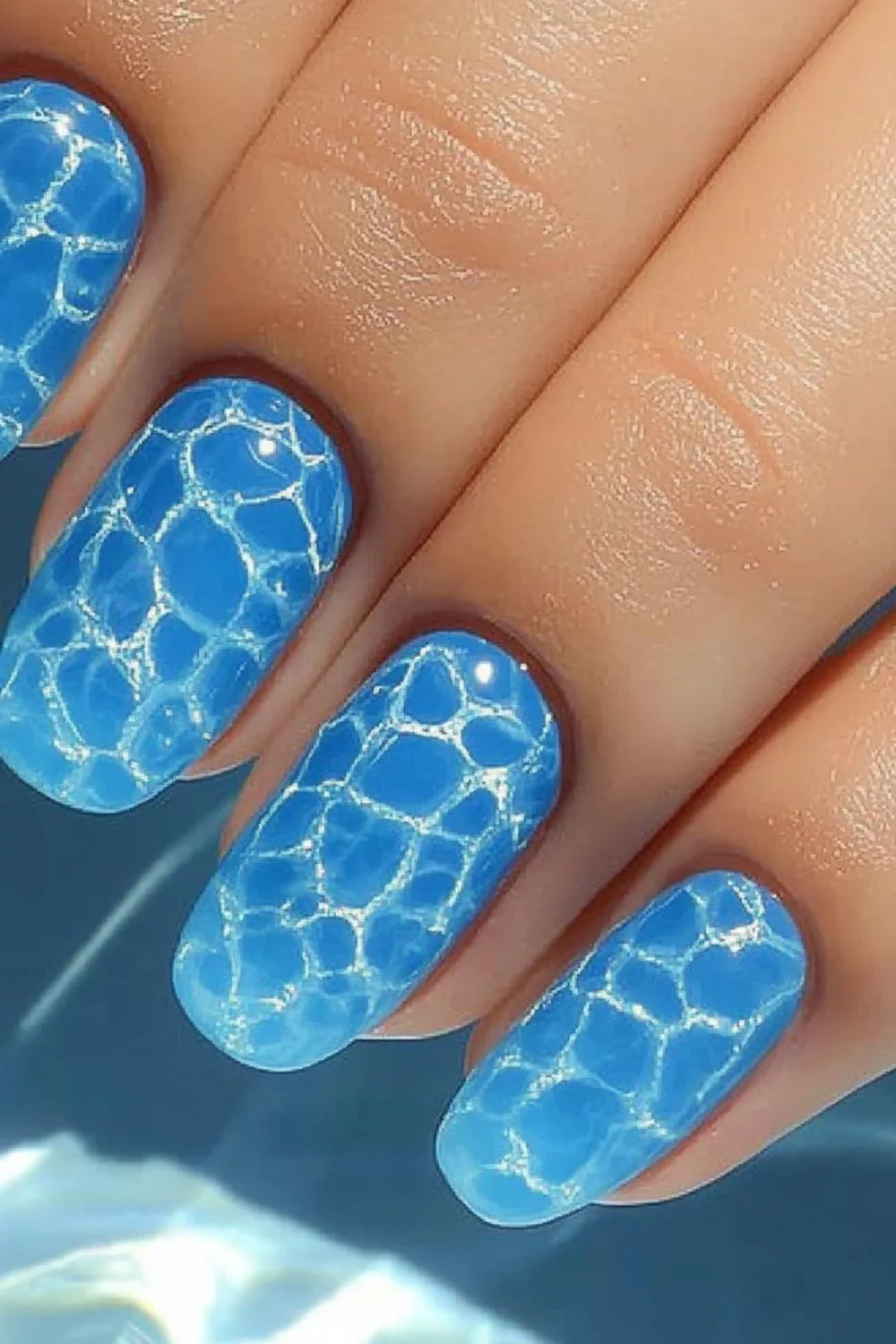 Blue water ripple nail design with a glossy finish