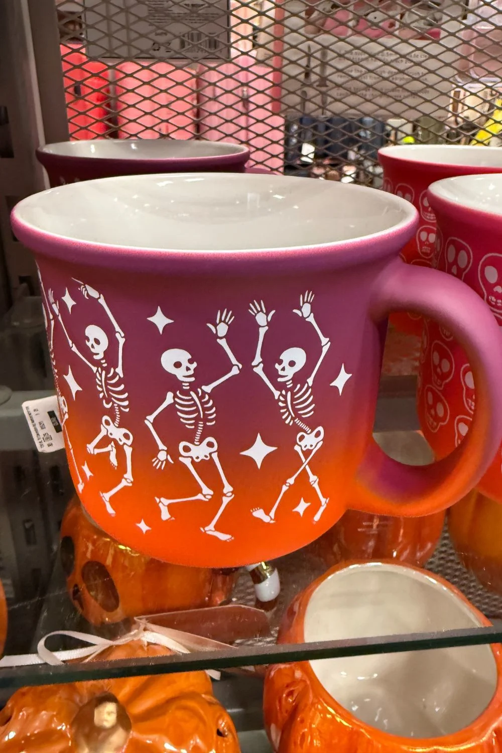 Large orange and pink gradient Halloween mug from TK Maxx with dancing skeleton design.
