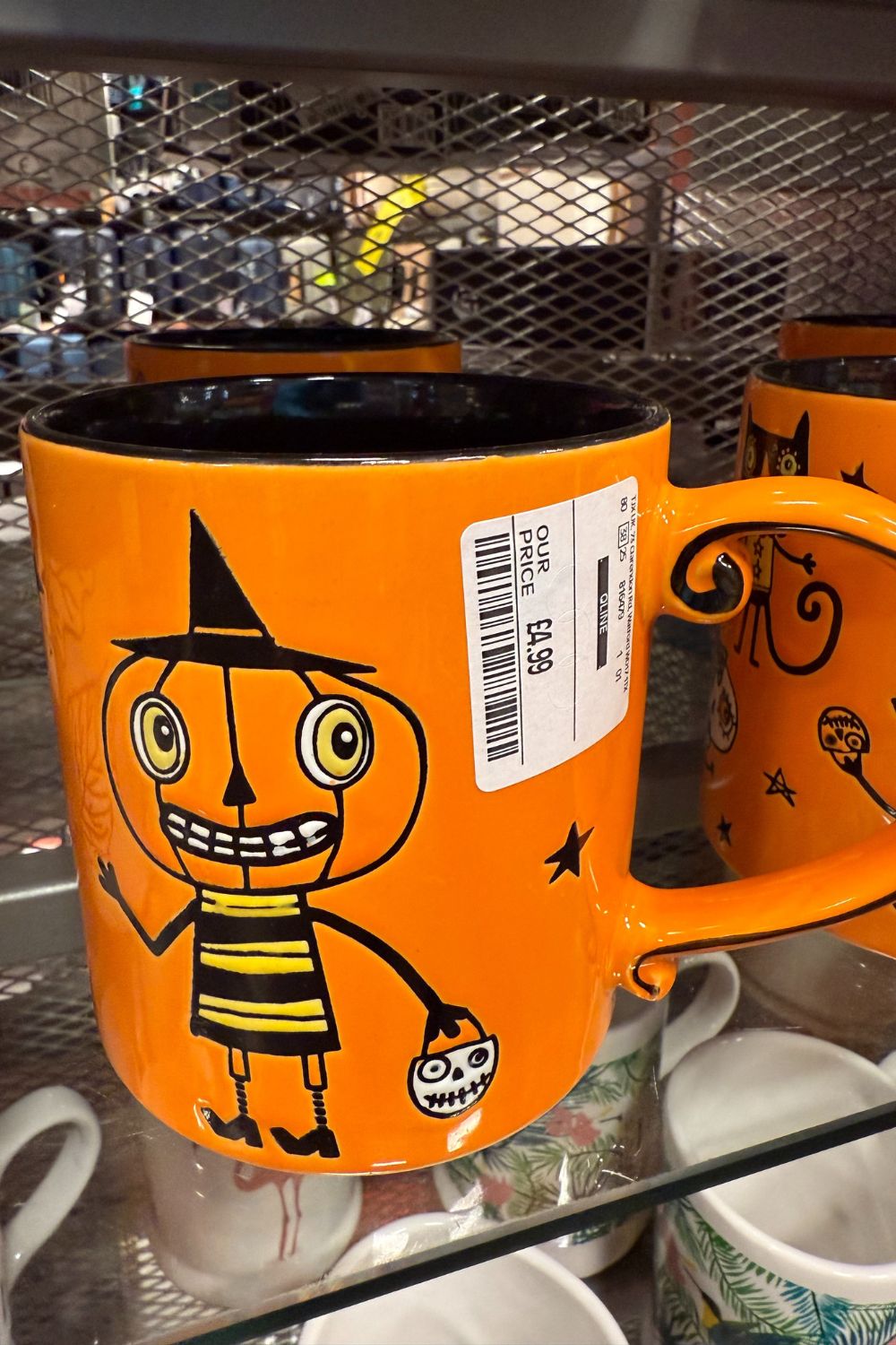 Orange Halloween mug with pumpkin character in witch&rsquo;s hat and skull bucket from TK Maxx.