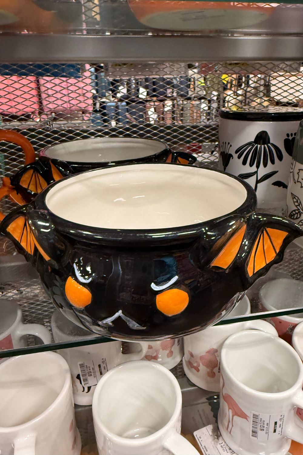 Black Halloween bat mug with orange eyes and wing-shaped handles from TK Maxx.