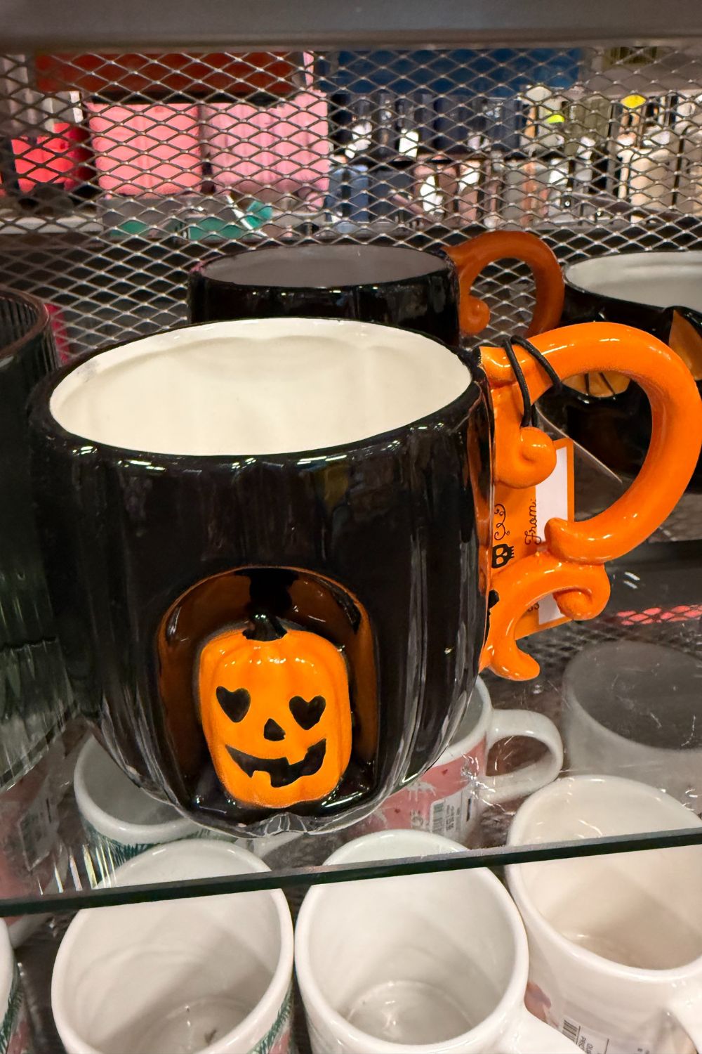 Black Halloween mug with 3D jack-o&rsquo;-lantern and orange curly handle from TK Maxx.
