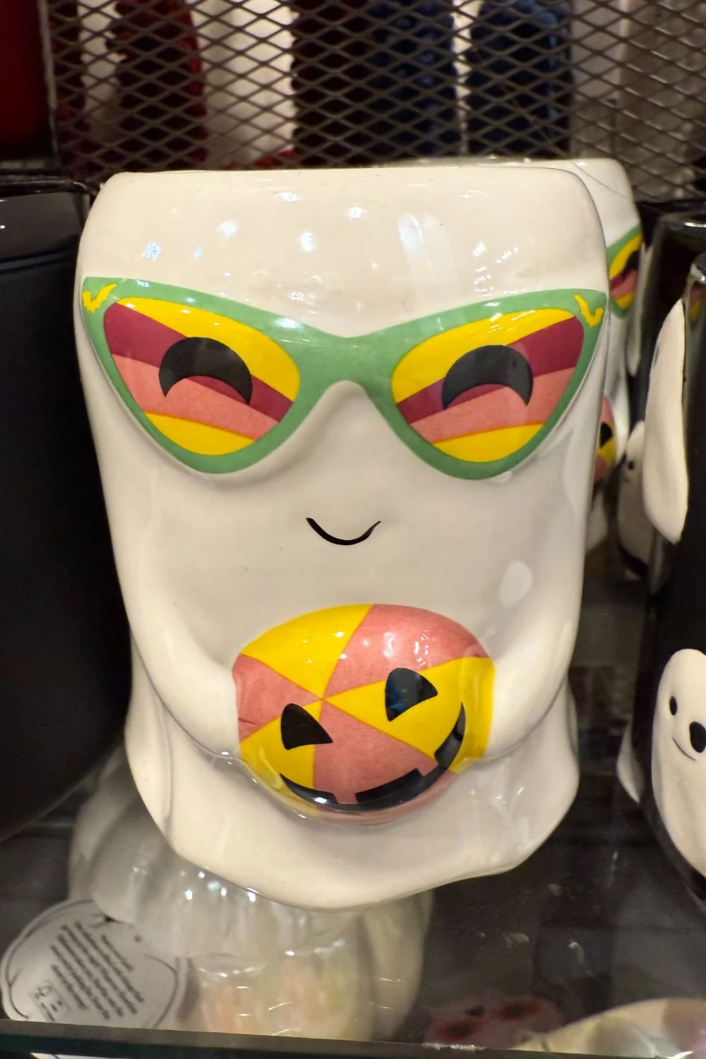 Halloween ghost candle with colorful sunglasses and pumpkin design from TK Maxx.