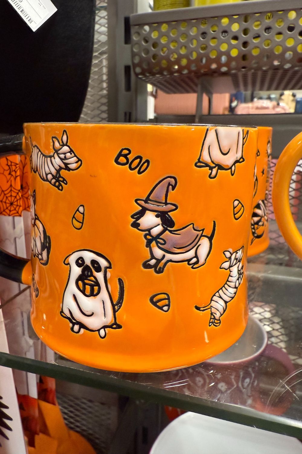 Orange Halloween mug with dogs dressed as ghosts, witches, and mummies from TK Maxx.
