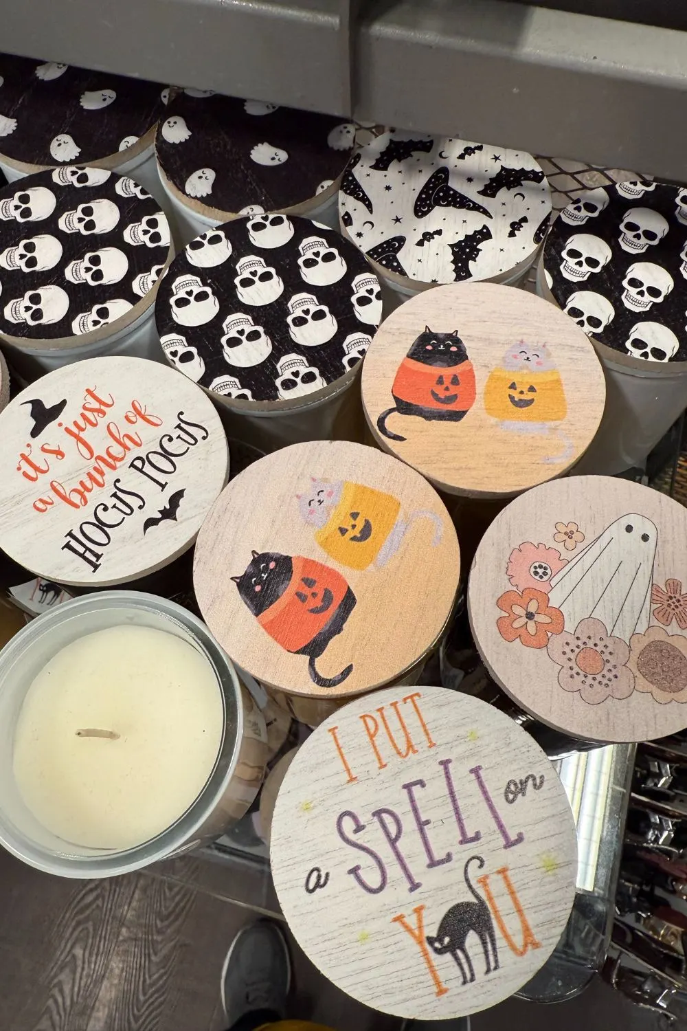 TK Maxx Halloween candles with printed wooden lids featuring cats, ghosts, bats, and spooky quotes.
