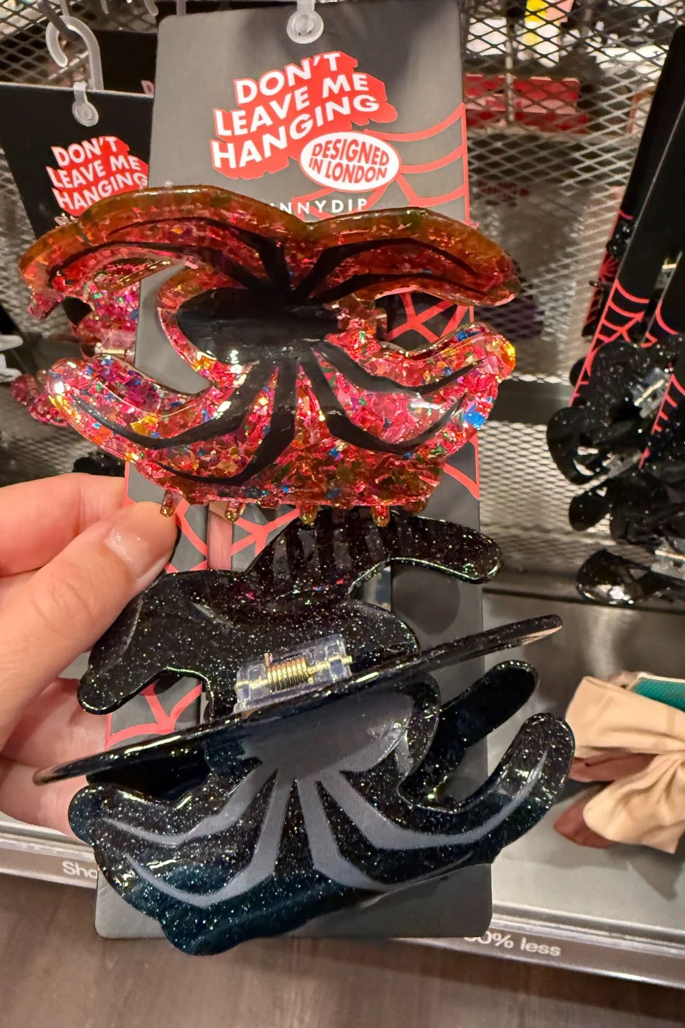 Red and black glitter spider-shaped Halloween hair clips.