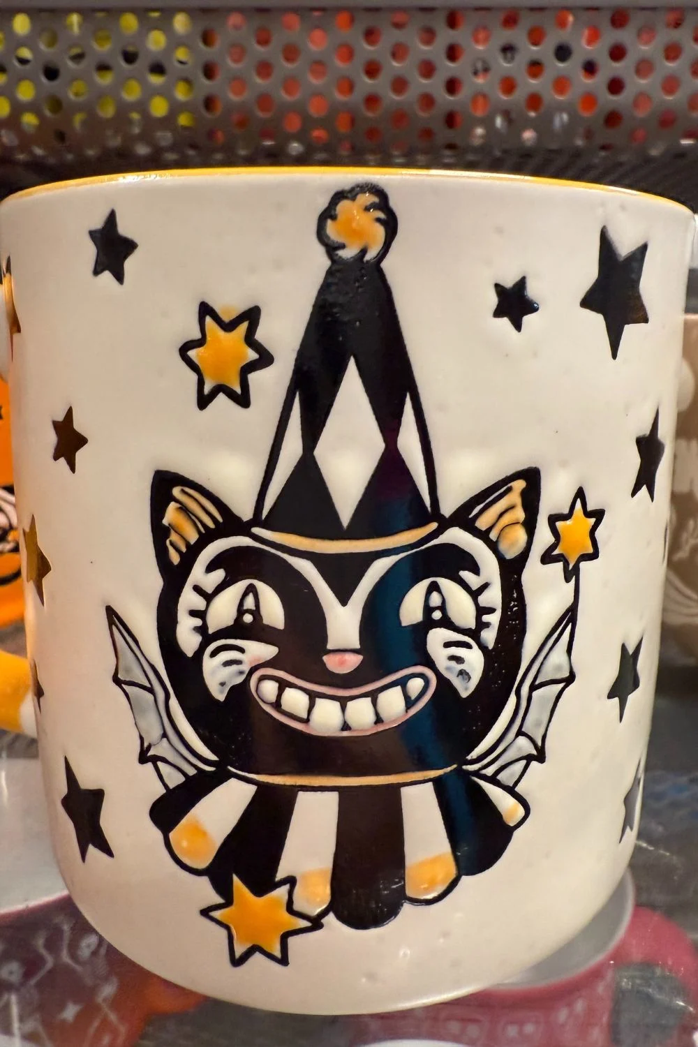 Halloween mug with black cat in party hat and golden stars from TK Maxx.