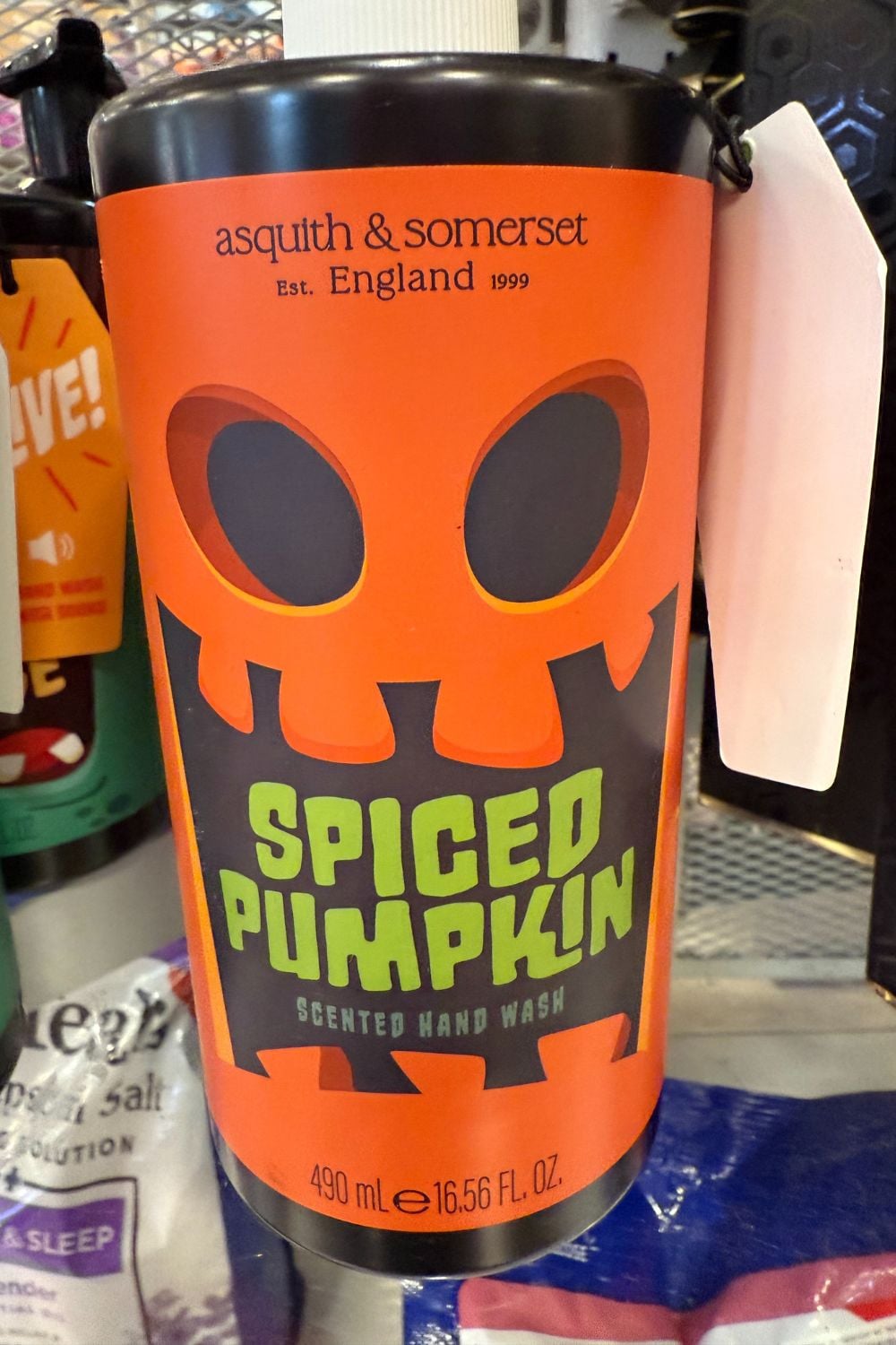 Orange bottle of Asquith & Somerset &ldquo;Spiced Pumpkin&rdquo; hand wash with jack-o&rsquo;-lantern design.