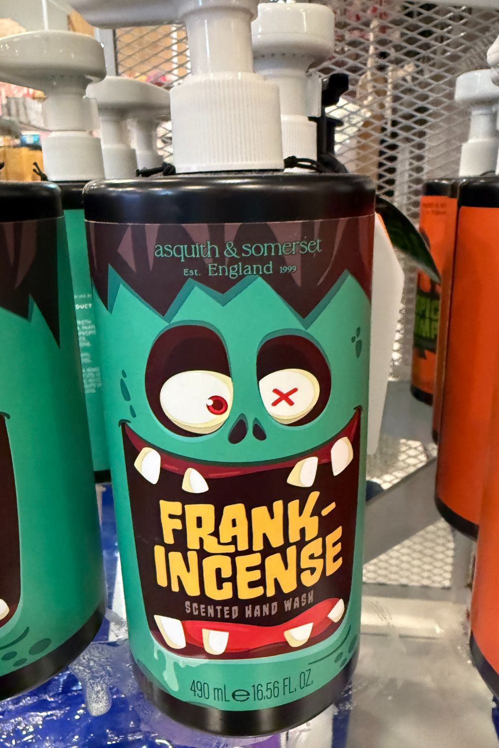 Green bottle of Asquith & Somerset &ldquo;Frank-incense&rdquo; hand wash with cartoon Frankenstein face.