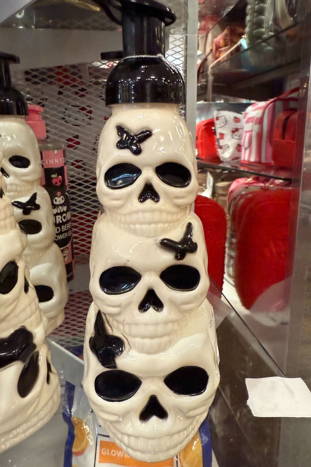 White stacked skull soap dispenser with black details and pump top.