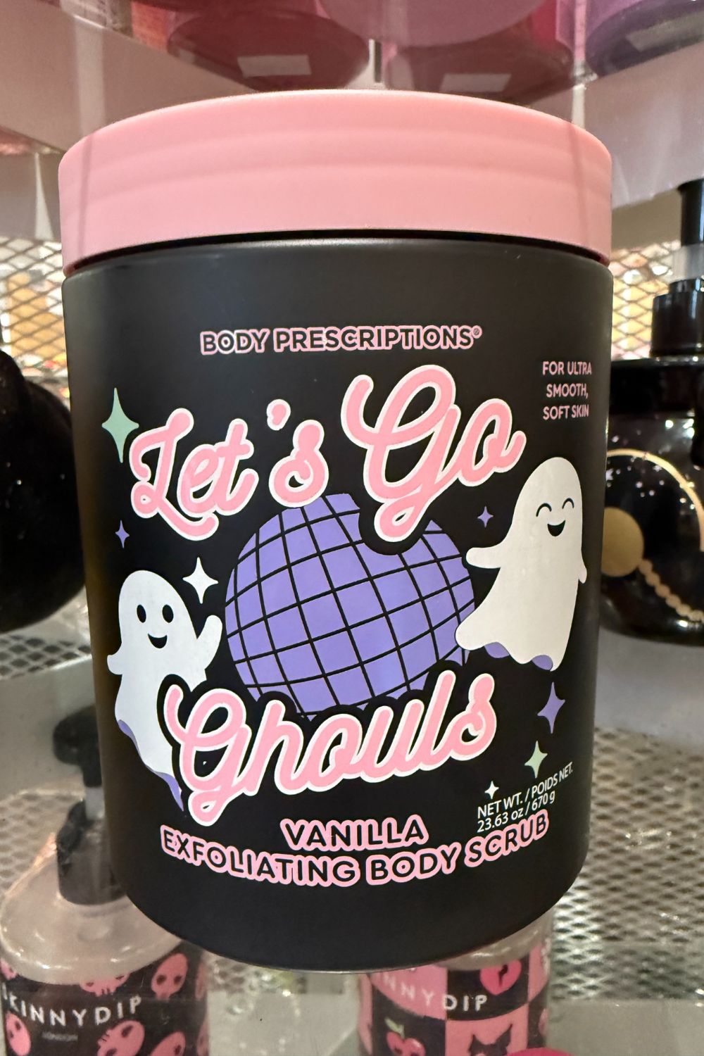 Black tub of Body Prescriptions &ldquo;Let&rsquo;s Go Ghouls&rdquo; Vanilla Exfoliating Body Scrub with pink lid and ghost design.