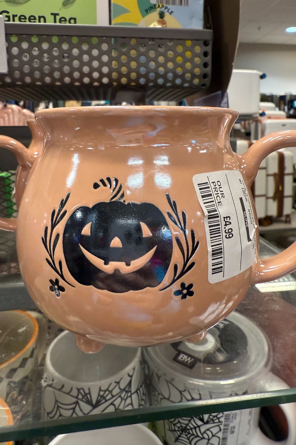 Peach cauldron-style mug with black pumpkin design from TK Maxx.