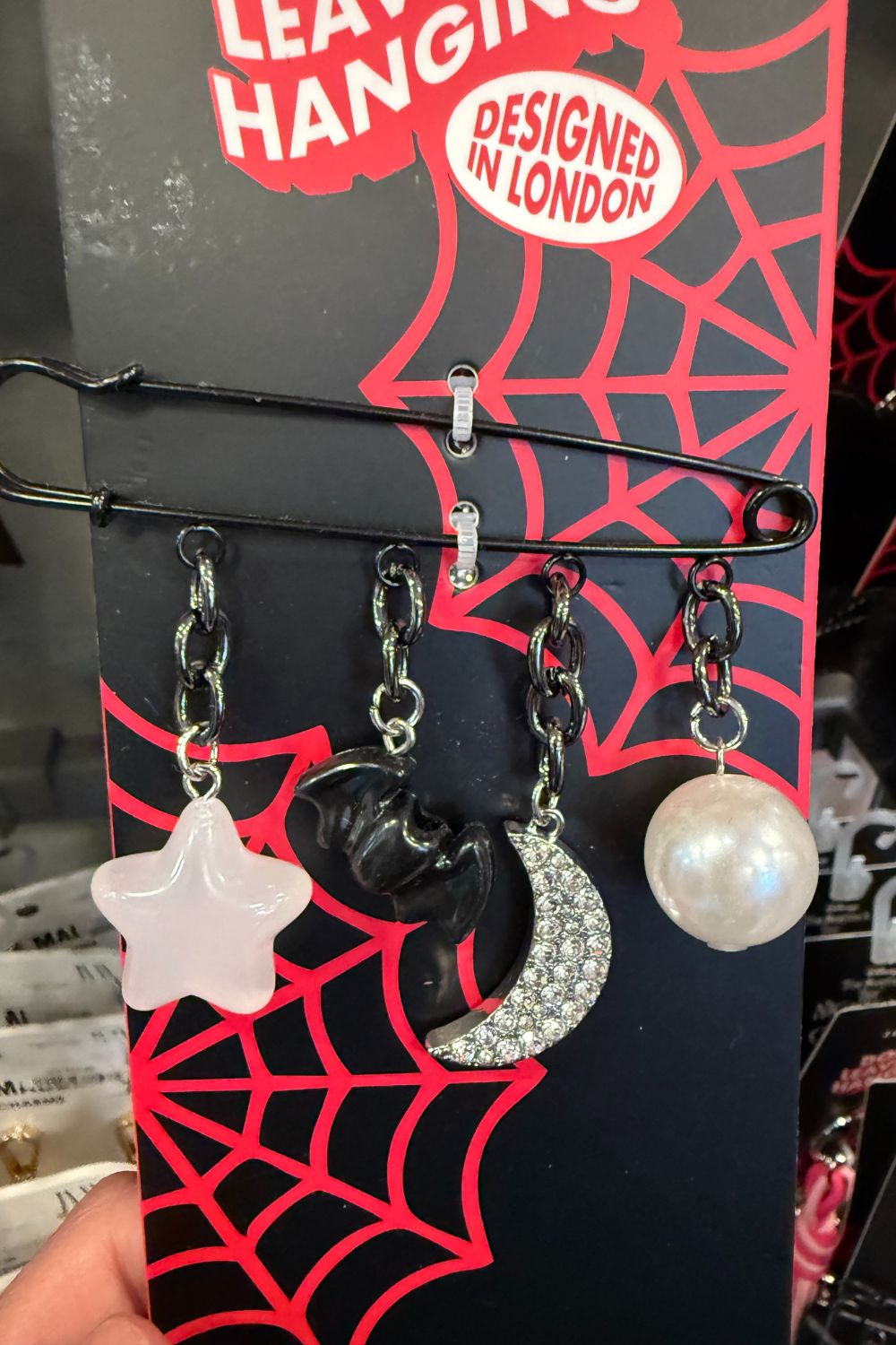 Halloween bag charm pin with star, bat, moon, and pearl charms.