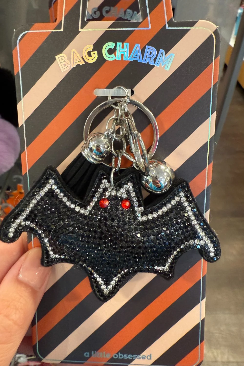 Black rhinestone bat bag charm with red eyes and tassel keychain.