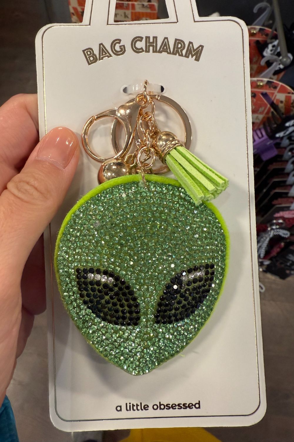 Green rhinestone alien face bag charm with tassel keychain.