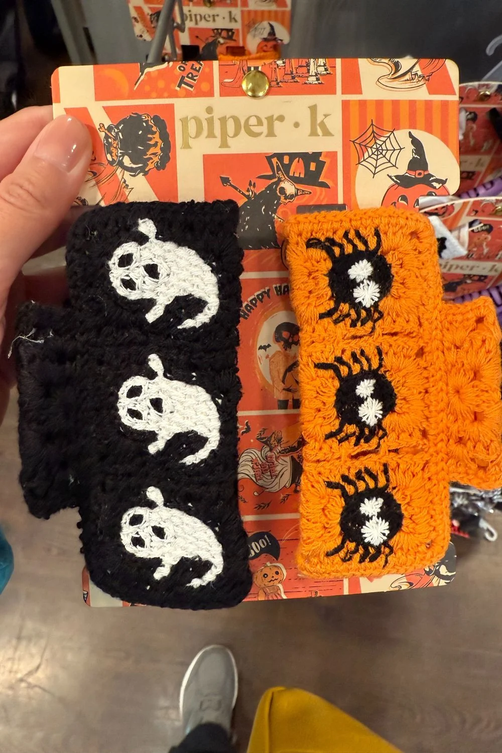 Crochet hair clips with ghost and spider designs in black and orange.