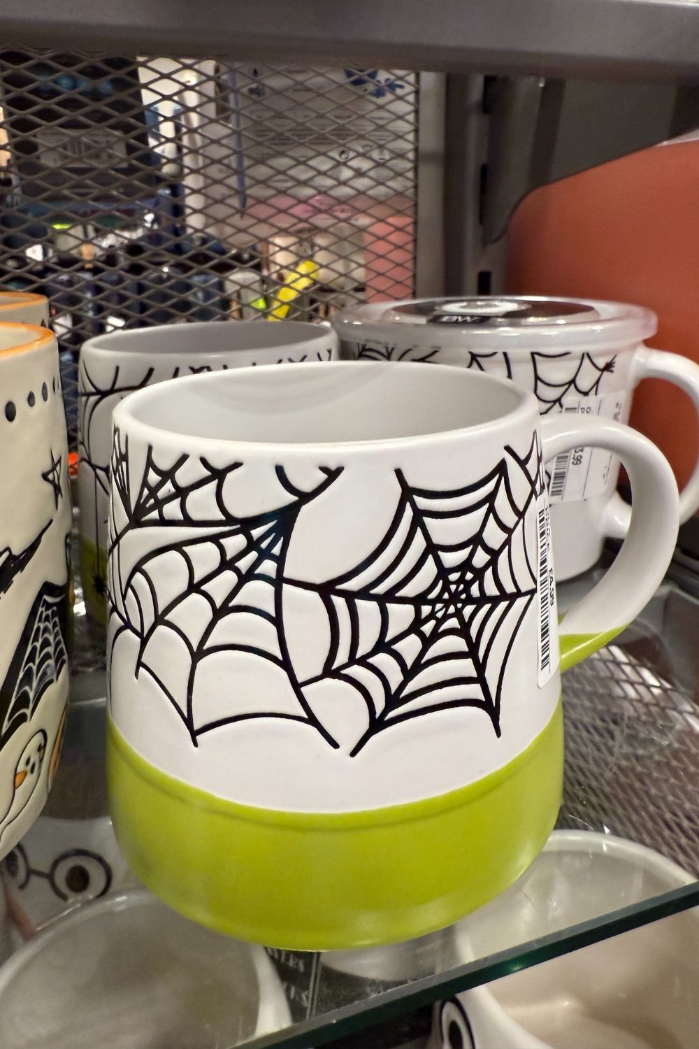 White and green Halloween mug with black spiderweb design from TK Maxx.