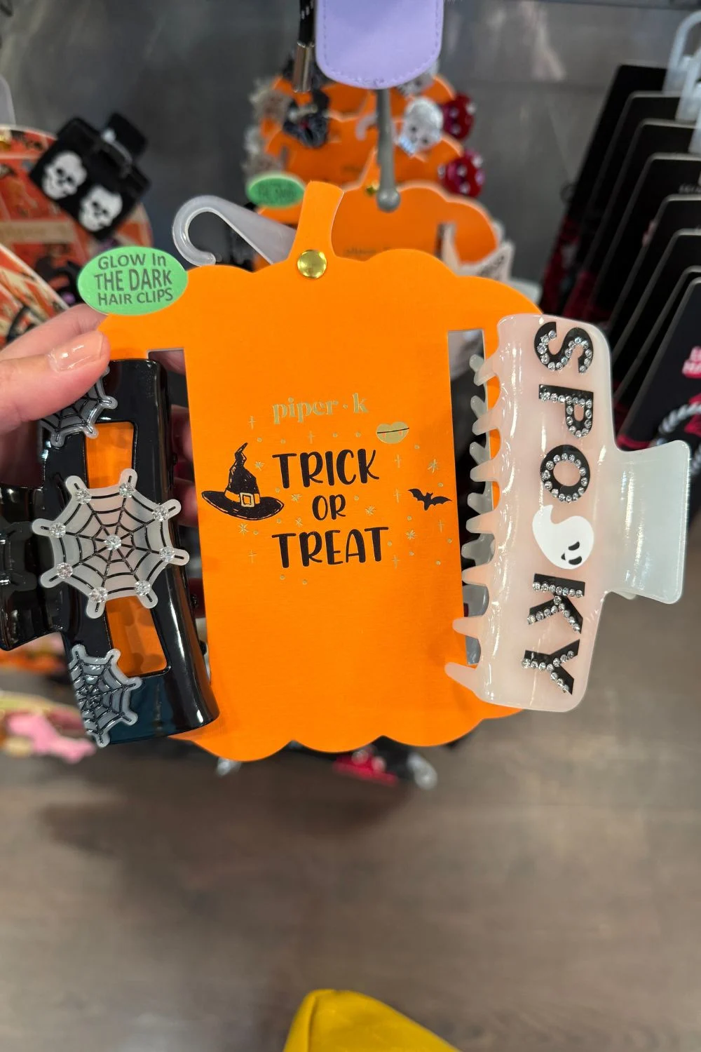 Black spiderweb clip and white spooky clip with glow-in-the-dark accents.