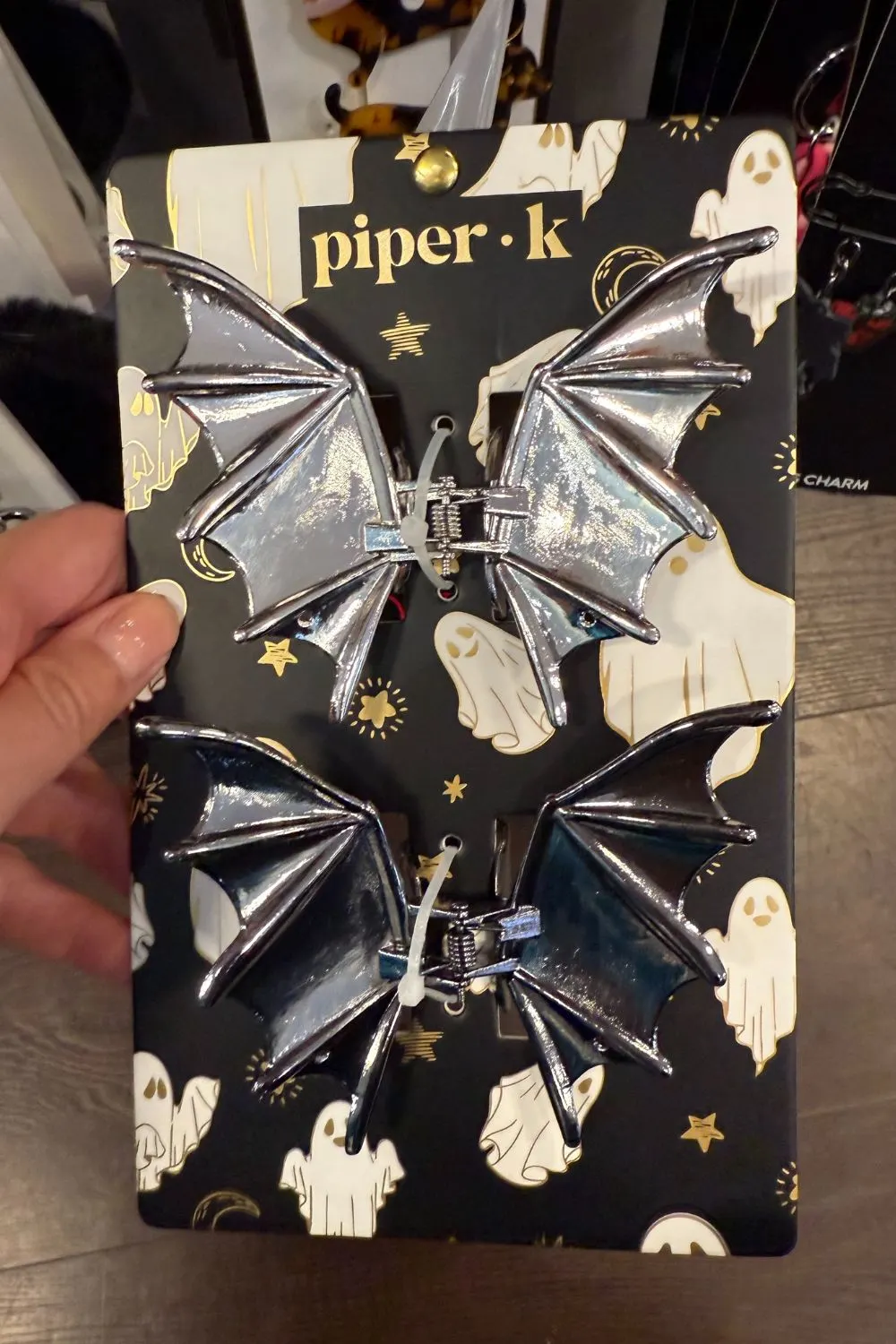 Silver bat-shaped hair clips with shiny metallic finish.