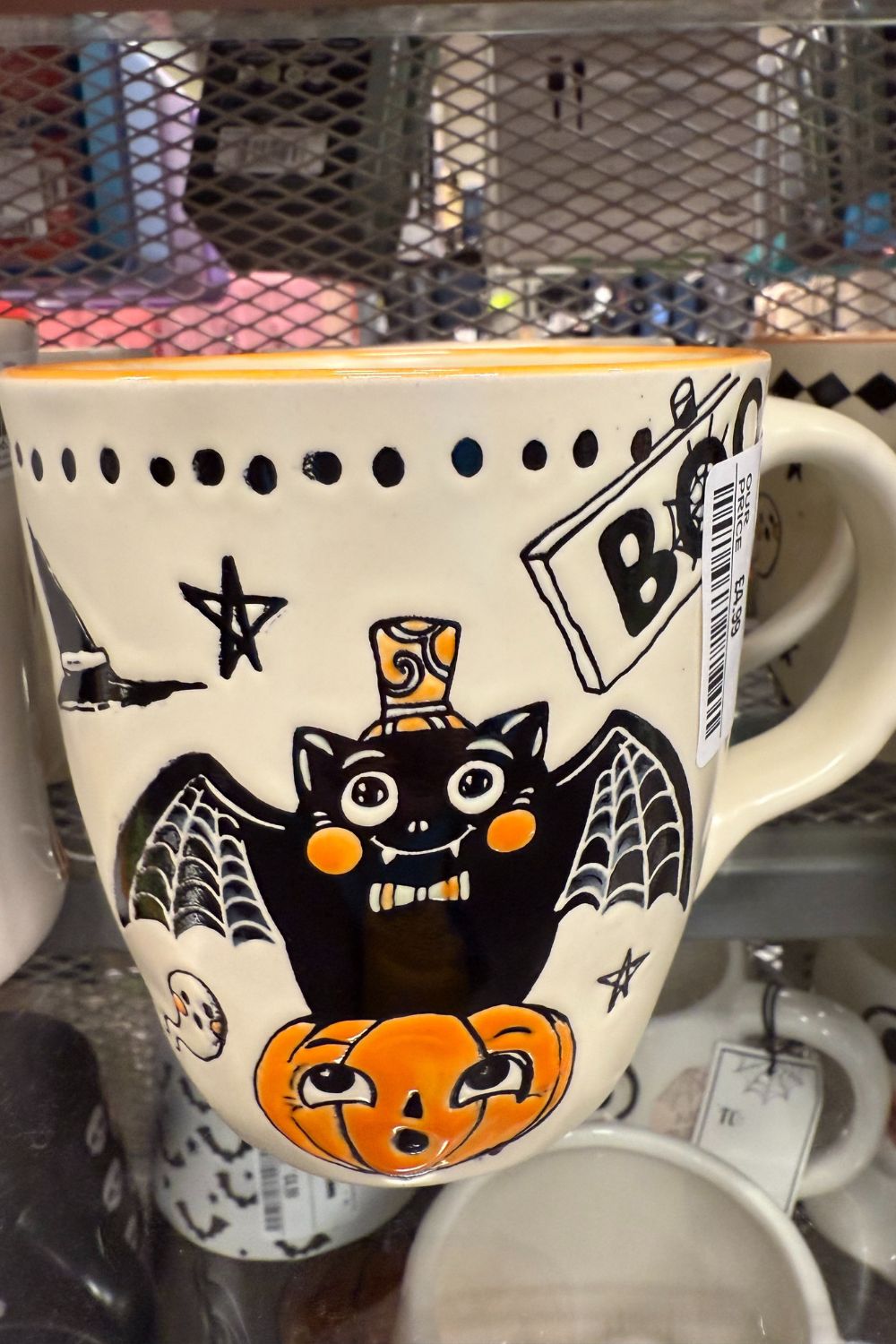Halloween mug with bat, pumpkin, and spider web design from TK Maxx.