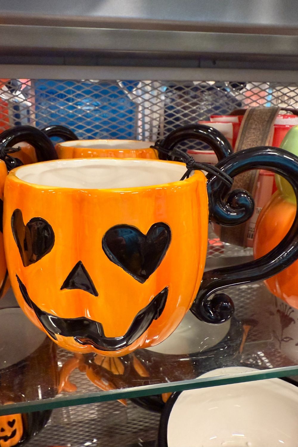 Orange pumpkin mug with heart-shaped eyes and curly handles from TK Maxx.